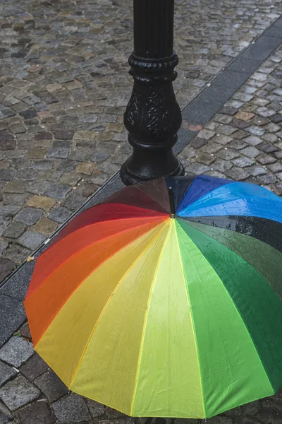 Multicolored umbrella in rainy day — Stock Photo, Image