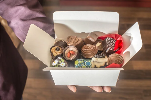 Hands holding box of chocolates