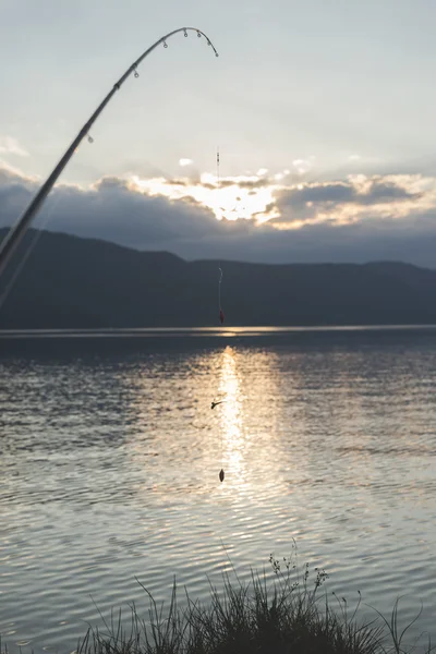 Fishhook over mountain lake — Stock Photo, Image