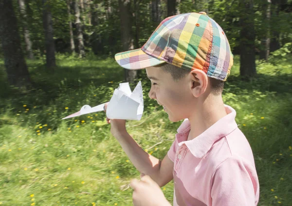 Child plaing with stork made of paper — Stock Photo, Image