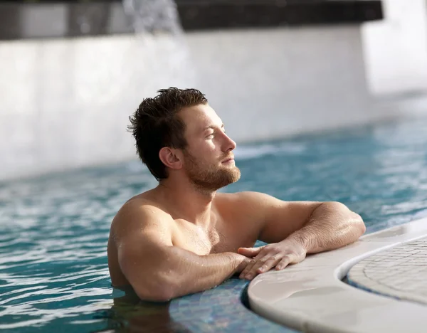 Homme penché au bord de la piscine — Photo