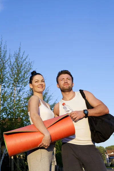 Woman and man in sports clothes — Stock Photo, Image