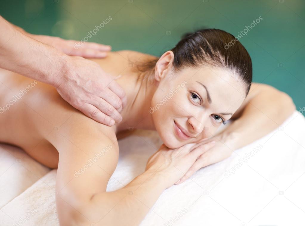 Beautiful woman in spa salon getting massage