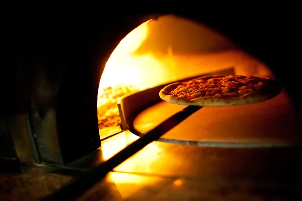 A pizza in a oven burning — Stock Photo, Image