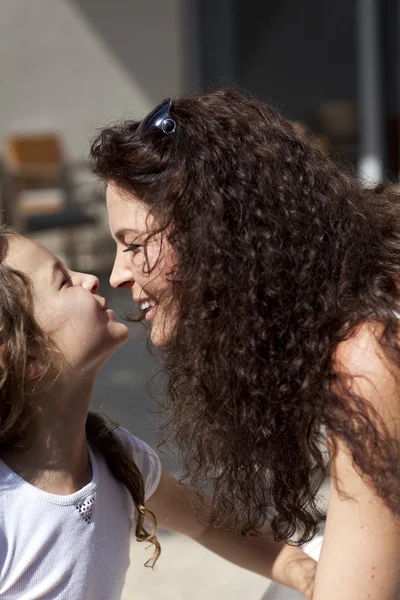 Mother and daughter smiling outdoor. — Stock Photo, Image