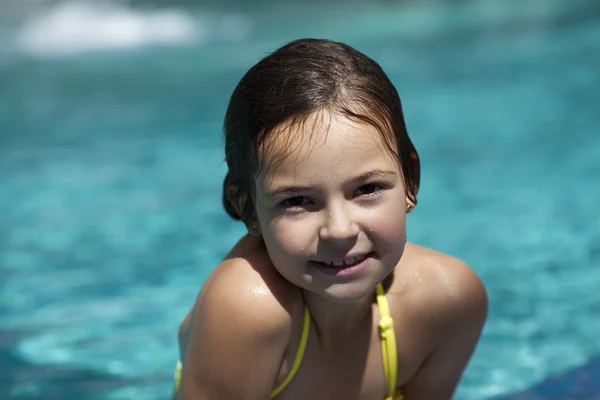 Girl child in blue water of the swimming pool — Stock Photo, Image