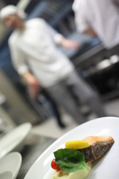 그들의 샐러드를 차압 하는 부엌에서 샐러드를 차압 하는 요리사 — 스톡 사진