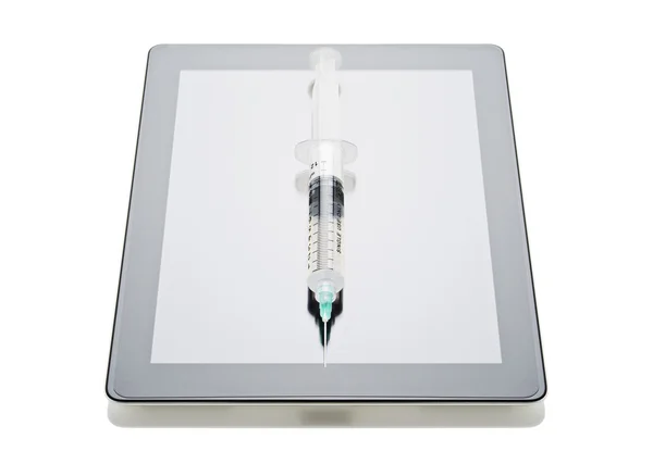 Syringe on digital tablet — Stock Photo, Image