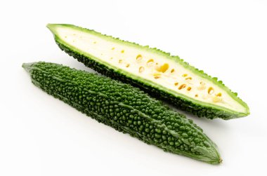 Cut half of bitter gourd on white background 