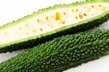 Cut half of bitter gourd on white background 