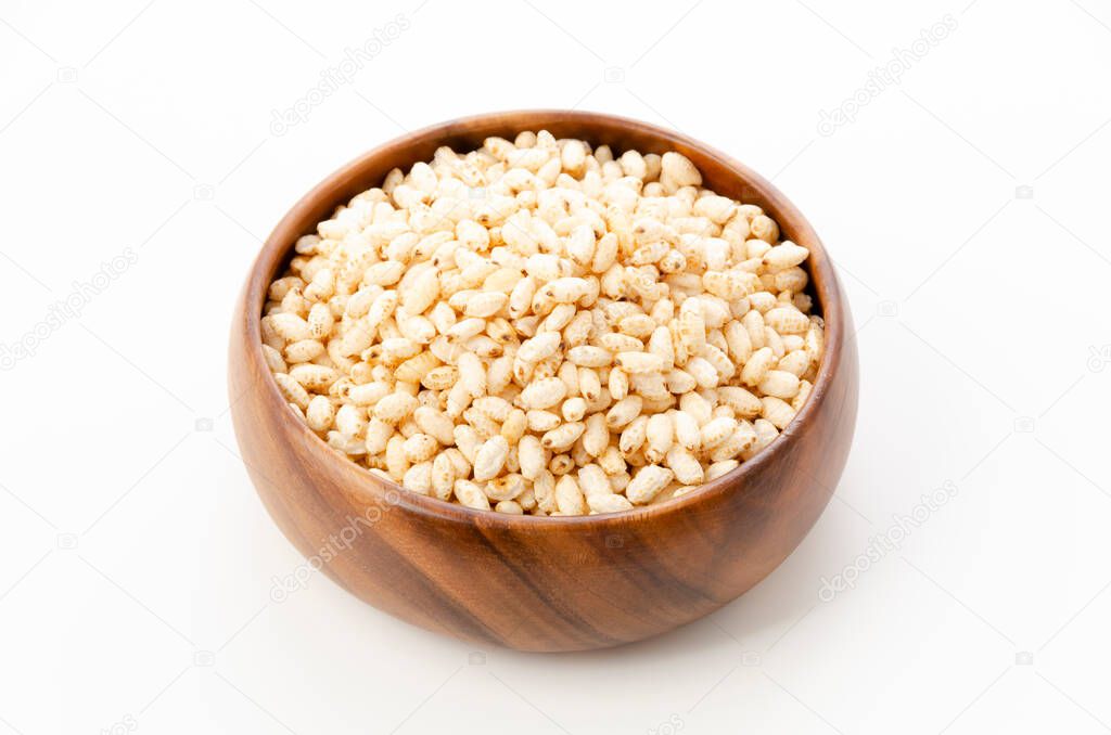 puffed rice in wooden round bowl on white background