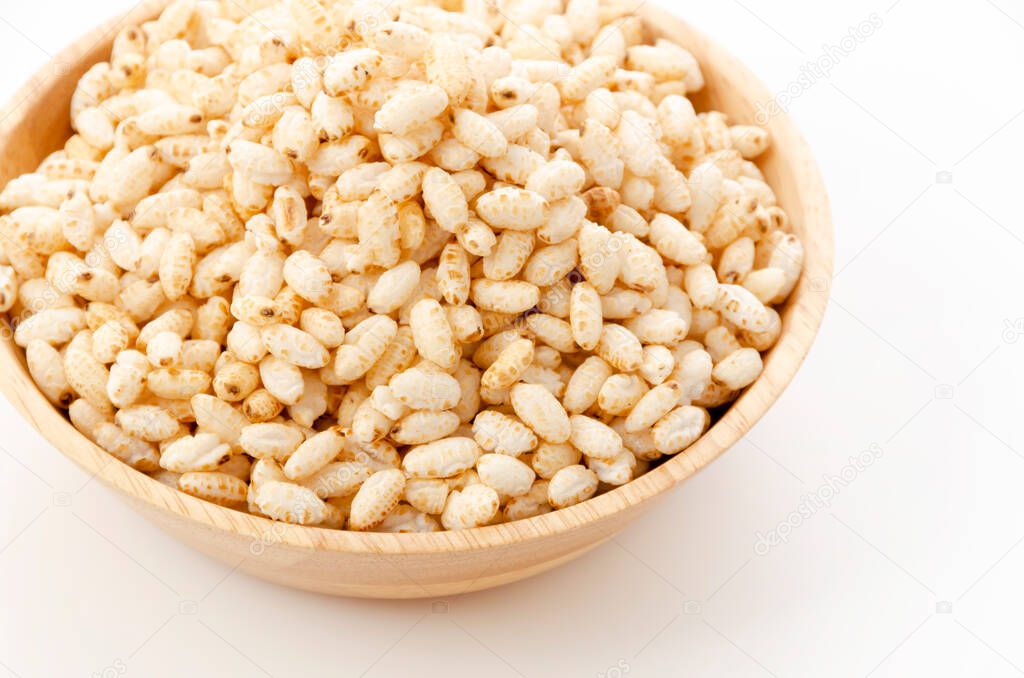 puffed rice in wooden bowl on white background