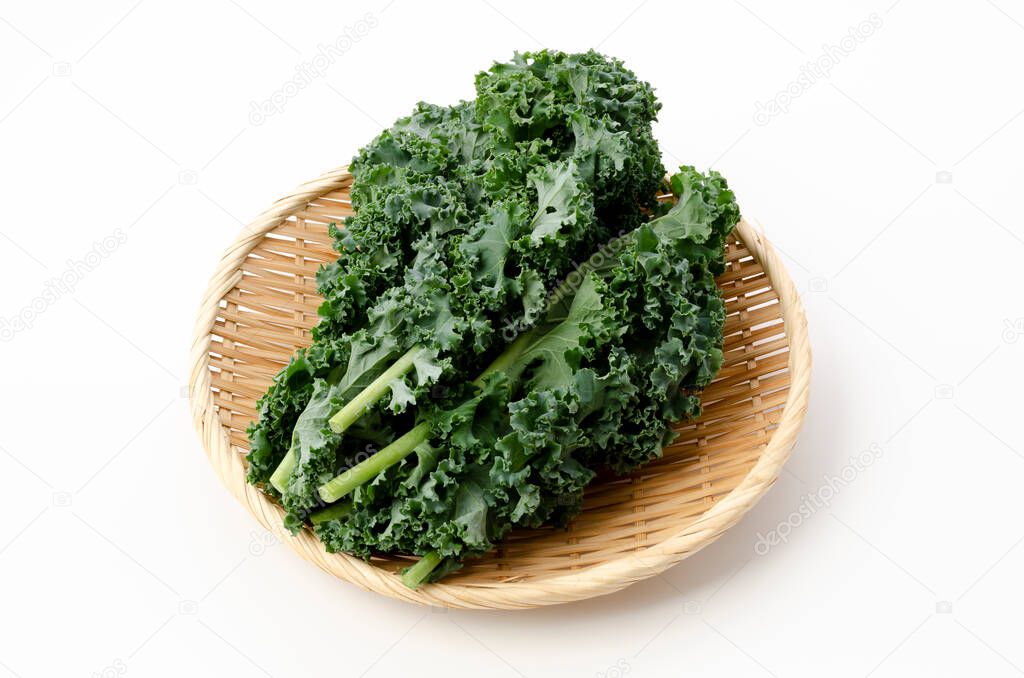 Fresh Curly green kale on bamboo sieve on white background