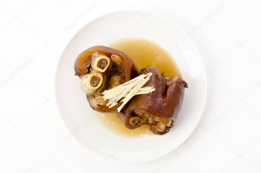 Stewed pork leg on white plate on white background