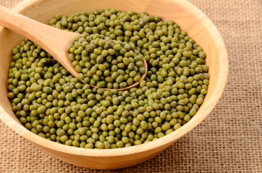 Beyaz kasede mung fasulyesi ve çuval bezinde kaşık