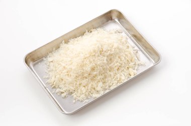 bread crumbs pile on stainless steel tray on white background.