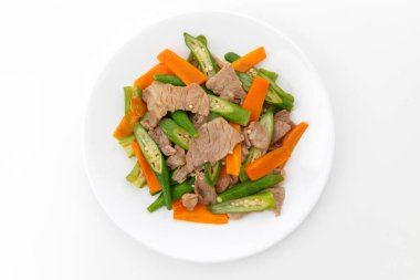 Japon yemeği, kızartılmış domuz eti, beyaz arka planda bamya ve havuç.