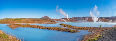 Panoramic view over geothermal active zones with power plants in Iceland, near Myvatn lake, summer and blue sky. clipart
