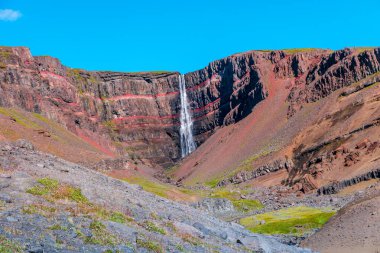 Güzel ve uzun İzlanda şelalesi Hengifoss, İzlanda, güneşli bir günde ve mavi gökyüzünde, yaz