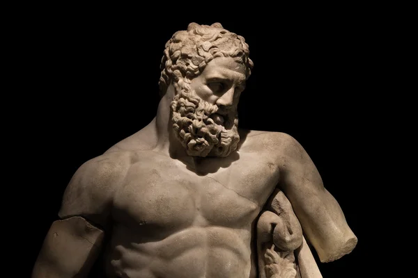 A statue of powerful Hercules, closeup, isolated in black — Stock Photo, Image