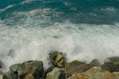 Denizin suyu kayalara çarpıyor..