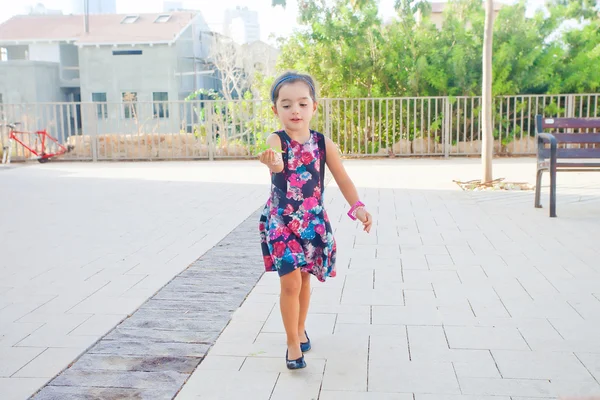 Cute little girl carrying leaves — Stock Photo, Image