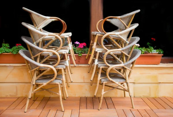 Piled chairs in front of window — Stock Photo, Image