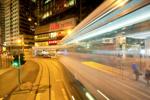 Night streets with skyscrapers and motion blur on dark road