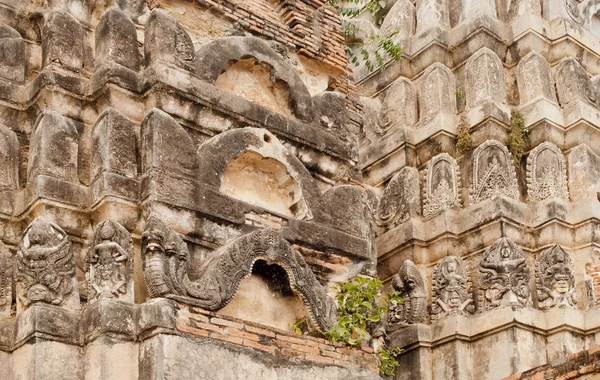 Mythenfiguren auf geschnitzten Türmen eines Tempels aus dem 12. Jahrhundert, Thailand. — Stockfoto