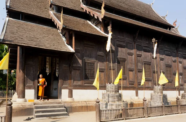 Orange robe of buddhist monk in entrance of 14th century wooden temple — 스톡 사진