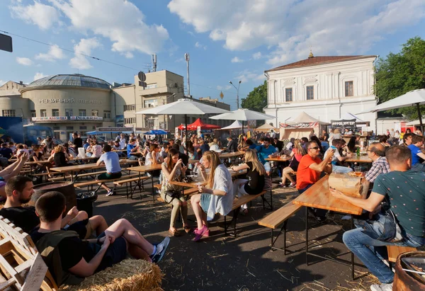 Fiatal nők és férfiak megvacsorázna a szabadtéri gyorsétterem-bíróság felhők — Stock Fotó