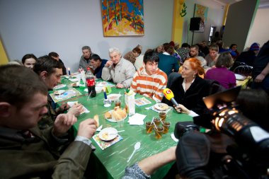 Poor men and women have a food at charity dinner