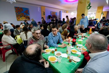 Different people talking at charity dinner for the homeless