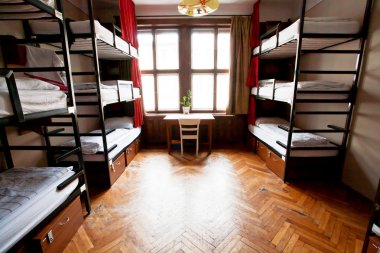 Three-level dormitory beds inside the hostel room clipart