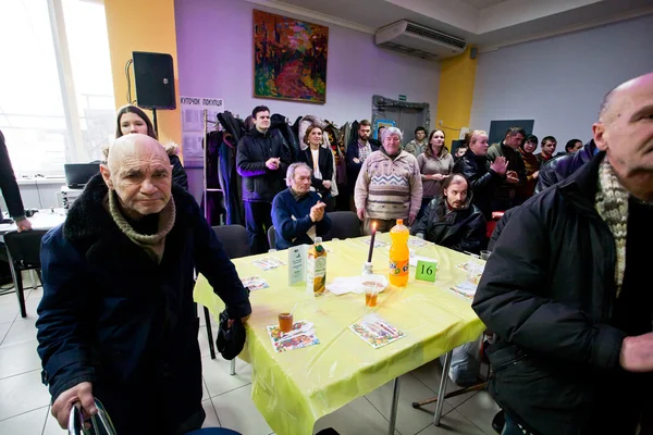 Poor people praying before lunch at charity dinner
