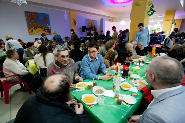 Different people talking at charity dinner for the homeless