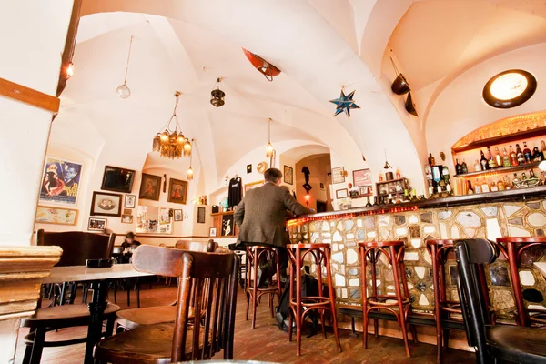 Men sit inside the cozy restaurant with alcohol menu — Stock Photo, Image