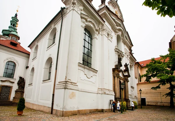 Touristen stehen in der Nähe des Eingangs zur weißen Kirche — Stockfoto