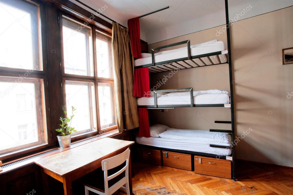Three-level dormitory beds inside the hostel room for six tourists or the students