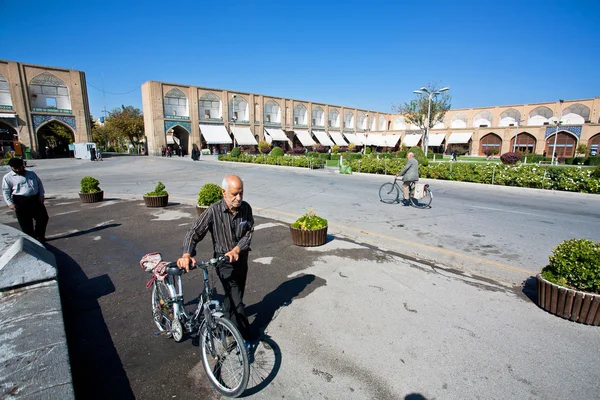 Senior with bicycle walk through the square — Stock Photo, Image