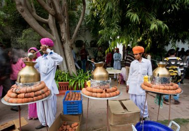 Men in traditional Rajasthan dresses prepare tea masala