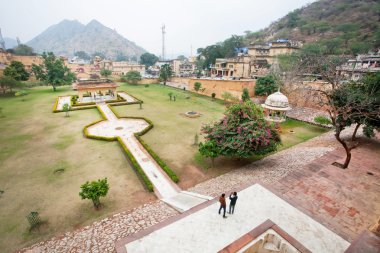 Courtyard with trees and historical structures of Amber Fort