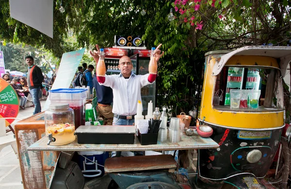 Bartender standing behind the weird street bar — Stock Photo, Image