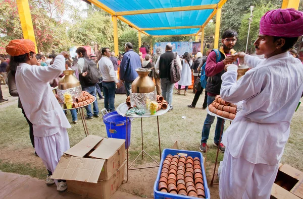 Men in traditional Rajasthan dresses prepare tea masala
