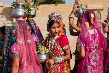 Woman in a crowd of friends dressed in sari
