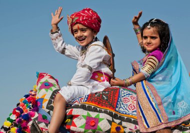 Happy children have fun in traditional dresses during carnival