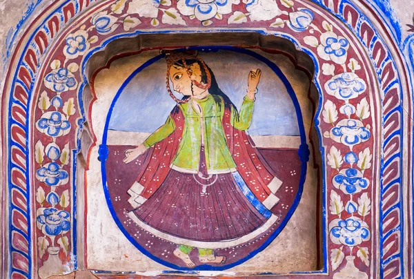 Woman dancing with fingers folded in the mudra on wall mural of the old house — Stock Photo, Image