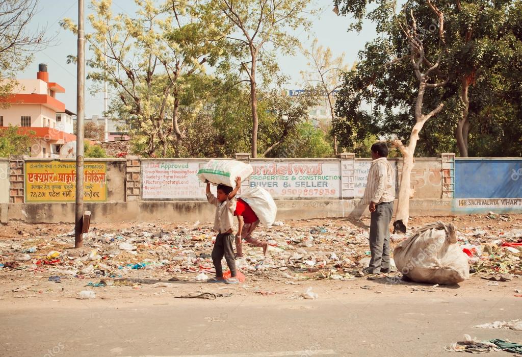 Poor children collect rubbish on the streets for recycling Stock