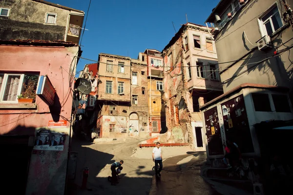Az emberek séta, közel a törött fal szegény street, Isztambul — Stock Fotó