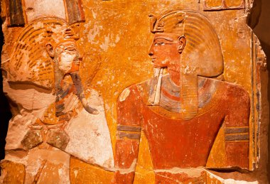 Artifact from ancient Egypt - relief of Pharaoh Seti I in front of the God Osiris